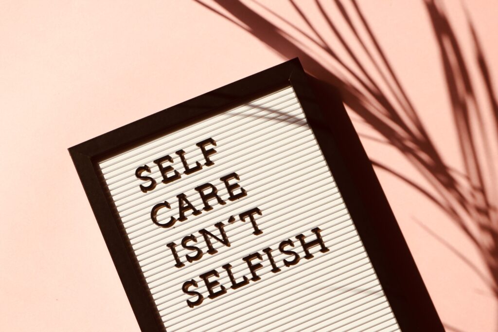 Image of a sign that reads self care isn't selfish