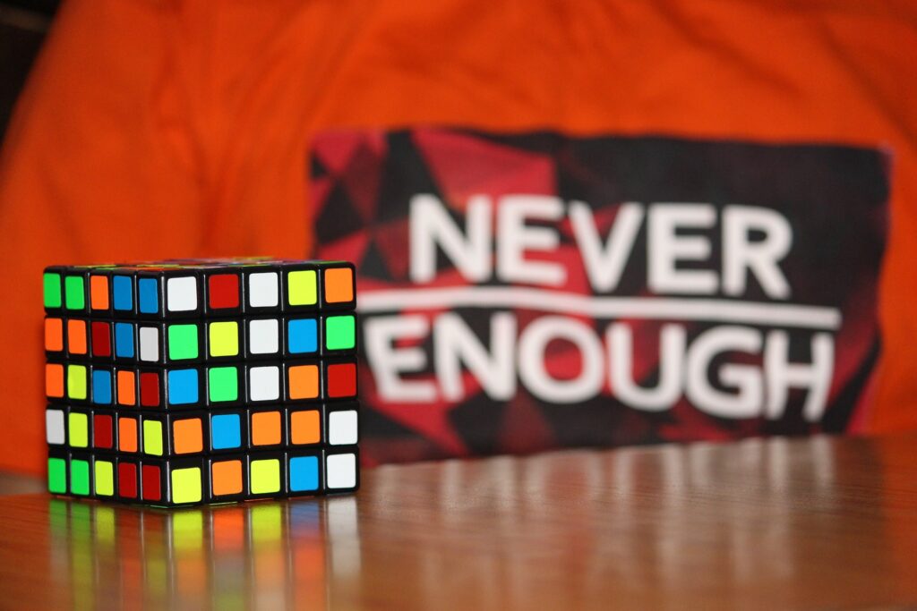 Image of rubics cube and a sign that says "never enough"