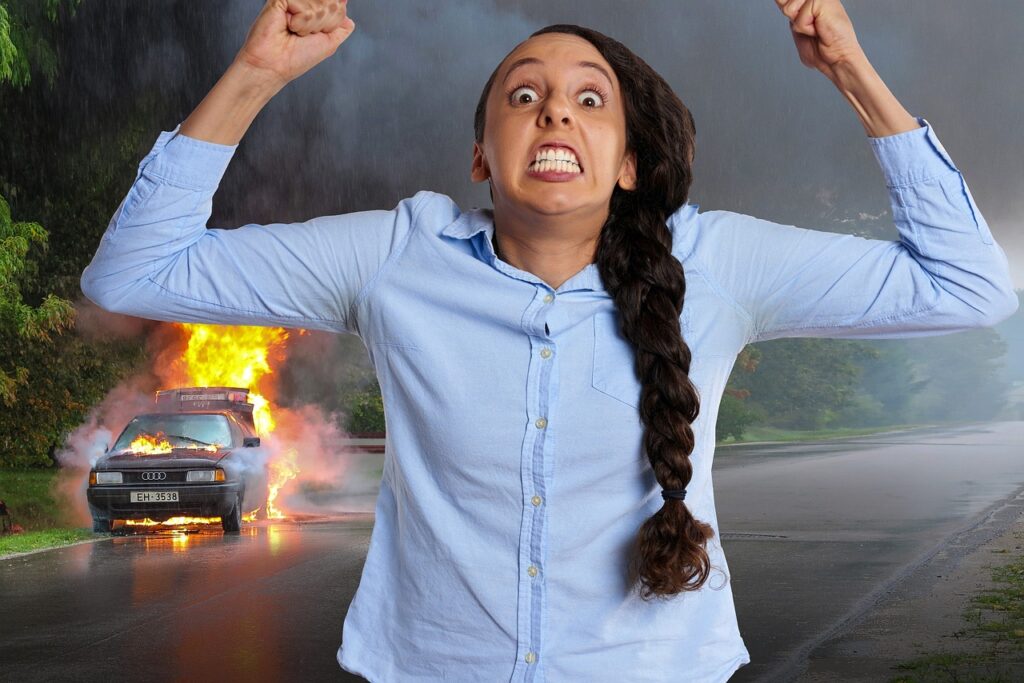 Image of a lady running from a burning vehicle