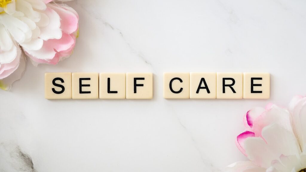 Image of Scrabble Tiles that read Self Care.