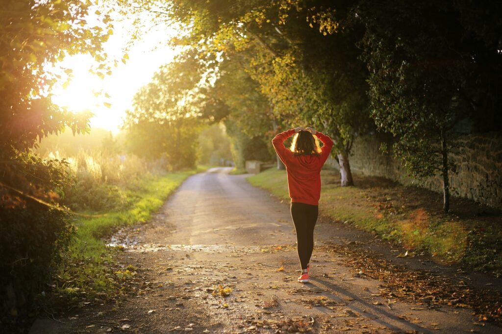 Image of a woman walking o a forest path