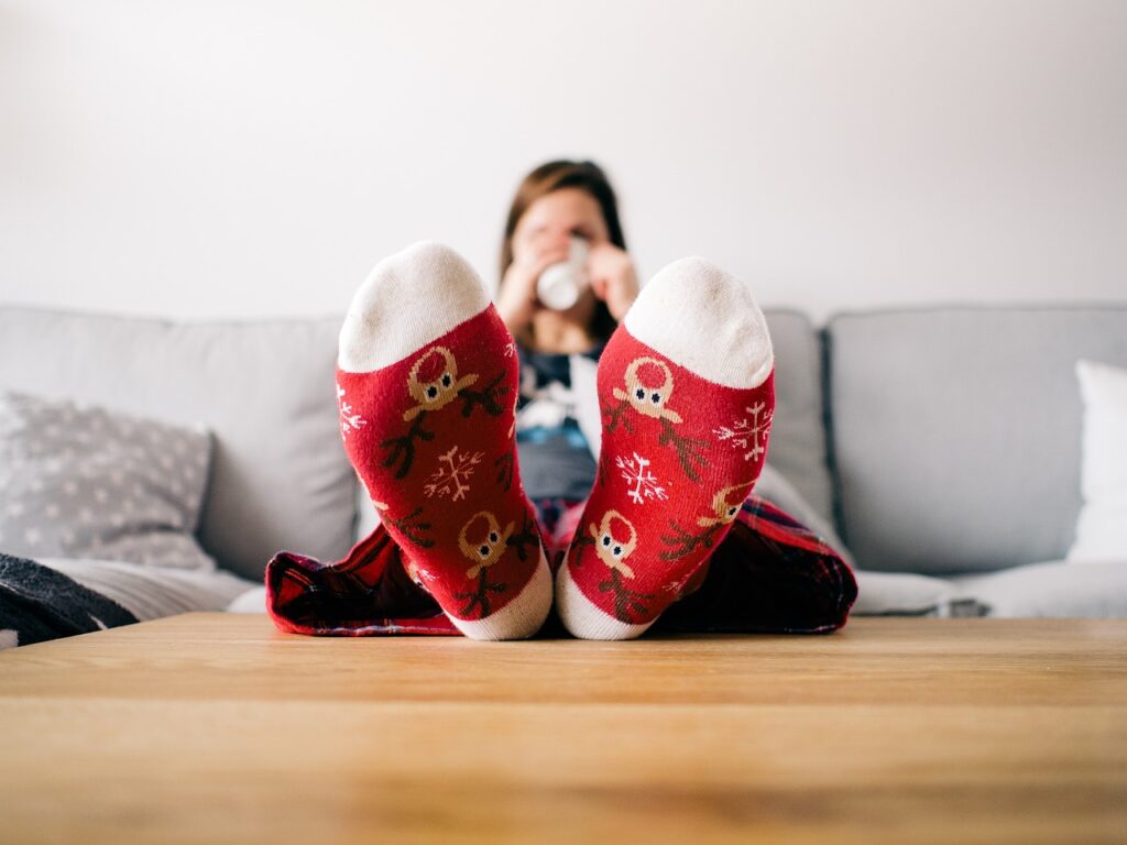 Image of woman in christmas socks practicing self-care